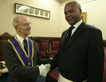 (l to r) The most senior Lodge member, WBro George Short, welcomes the most junior, Bro Johan-Christ Moukoko