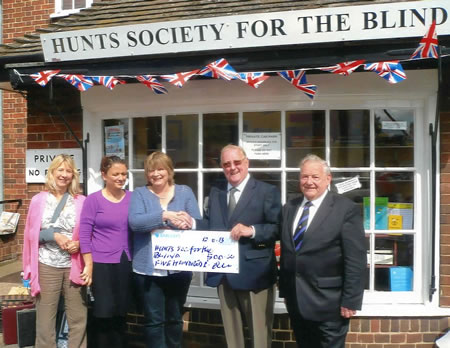 (l to r) WBro Geoffrey Barnes & Bro Mervyn Agger present the cheque to representatives of Huntingdon Society for the Blind