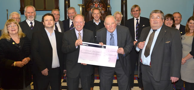 VWBro Dr Vivian Thomas (left centre) presents the cheque to PCTA Chairman, Keith Fisher with Masonic fund raising co-ordinator, WBro Mervin Roberts (front right) and Andrew Poynter, Head of Radiotherapy, Peterborough Hospital (front left)